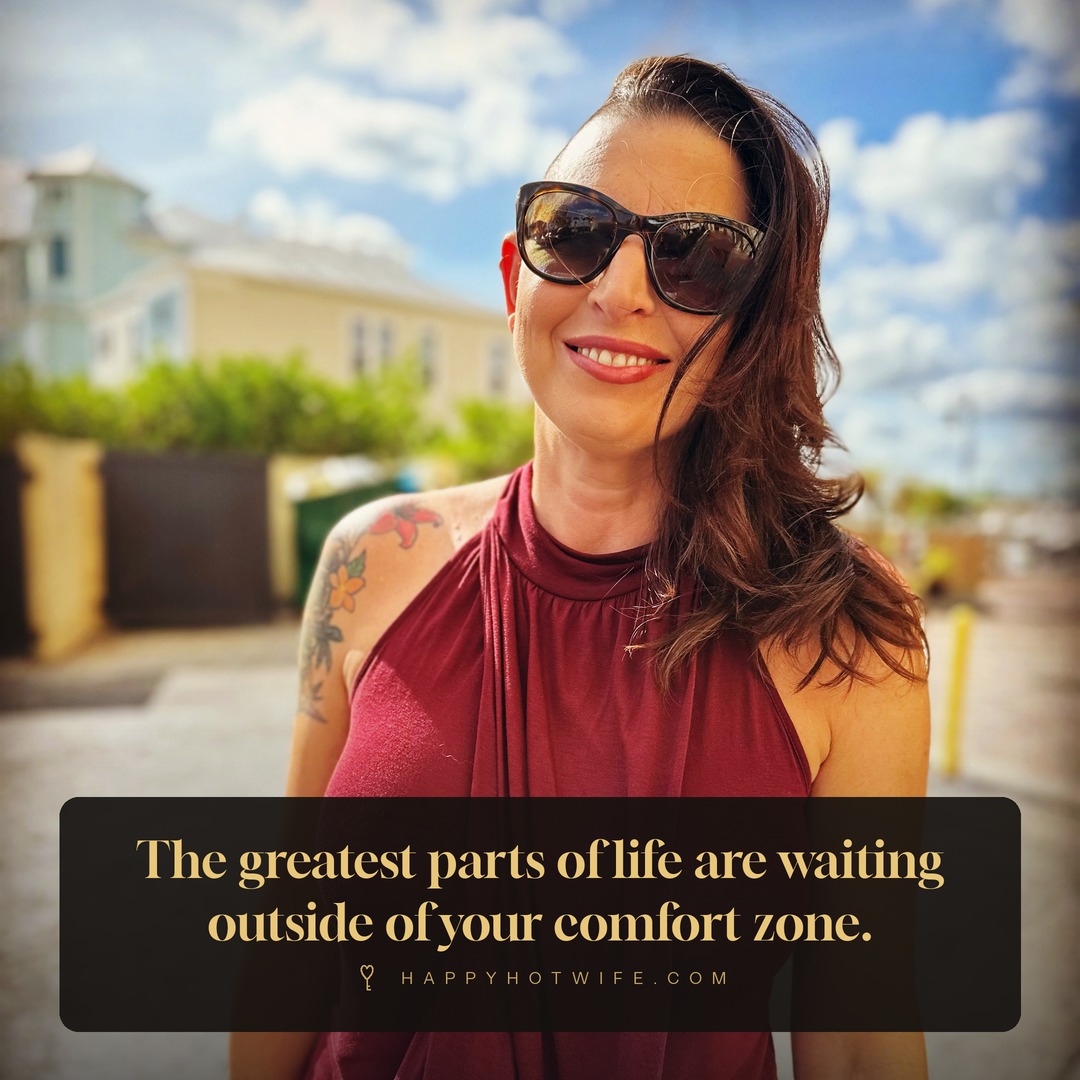 "The greatest parts of life are waiting outside of your comfort zone." Quote from Becoming Happy Hotwife. Happy Hotwife outdoors in a red halter dress.